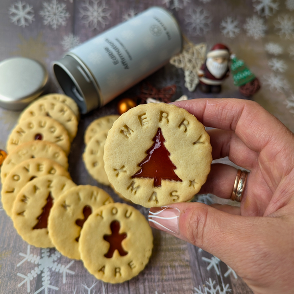 A photo of a biscuit with the words "Merry Xmas" and a wreath on it