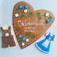 Bespoke Oktoberfest biscuits: large gingerbread heart with icing, lederhosen, & dirndl dress cookies