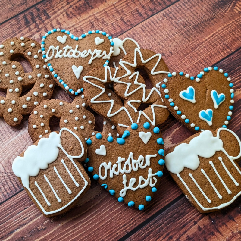 Bespoke Oktoberfest biscuits: pretzels, beer steins, & gingerbread hearts with festive blue & white icing. 