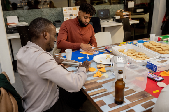 Group of people decorating biscuits in a fun Biscuit Decorating class