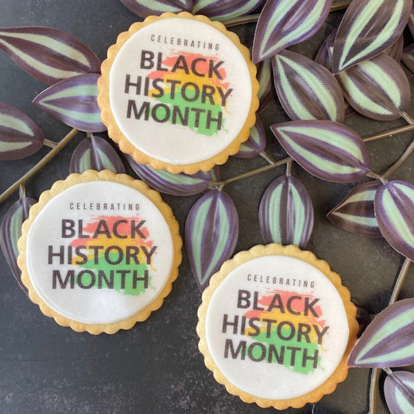 Black History Month Biscuits: Three round biscuits decorated with the words "Celebrating Black History Month" in vibrant colours.