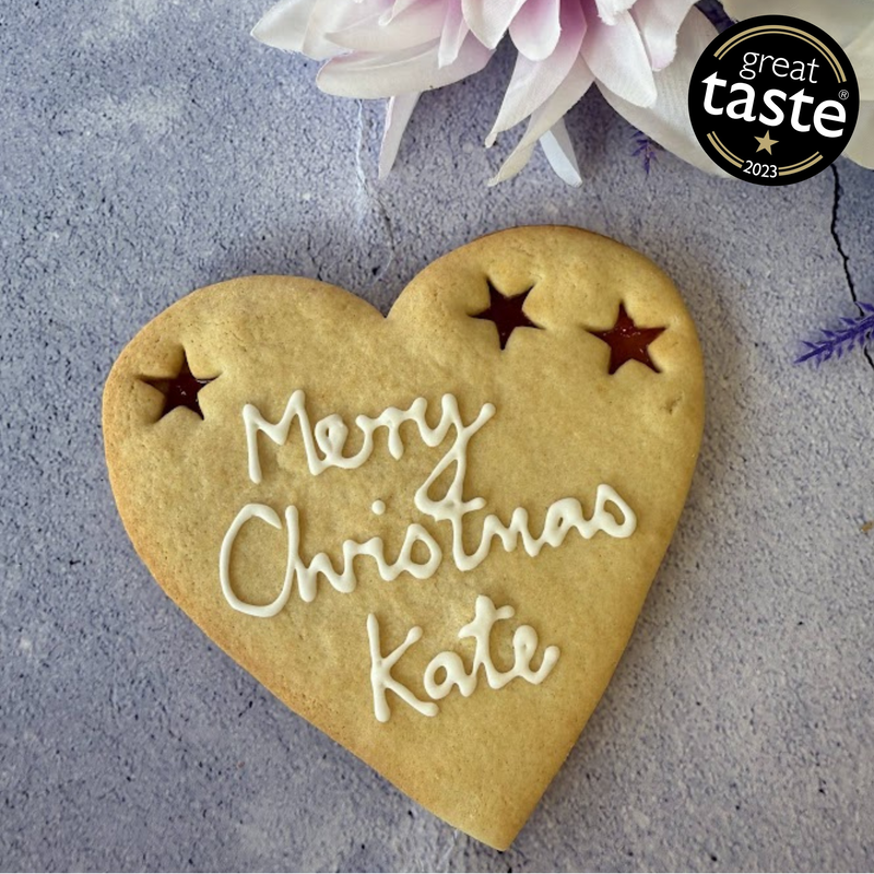 Giant Merry Christmas Cookie with "Merry Christmas Kate" piped in icing and three star-shaped jam cut-outs.