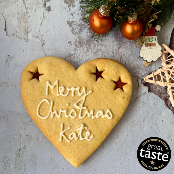 Giant Merry Christmas Cookie with "Merry Christmas Kate" piped in icing and three star-shaped jam cut-outs.