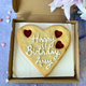 Giant personalised Happy Birthday cookie with "Happy Birthday Amy" piped in icing and hearts-shaped jam cut-outs.