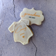 Pregnancy Announcement Biscuits decorated with a baby onesie and the words "Coming Soon," with a separate biscuit shaped like a speech bubble saying "Grandma" and "Dec 2024."