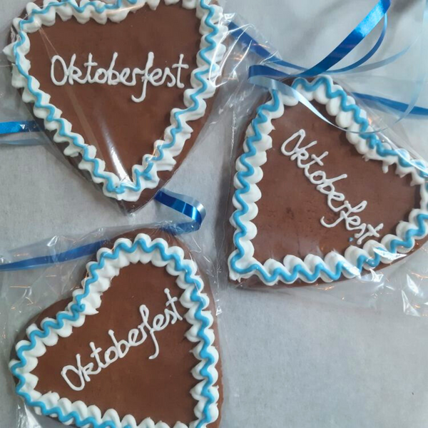  Three individually wrapped gingerbread Oktoberfest heart biscuits with blue & white icing