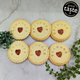 Close-up of round biscuits that spell out "CONGRATS GRADUATE" with a heart in the center