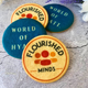 Four round butter cookies printed with colourful "Flourished Minds" logo