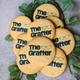 Round butter biscuits with colourful "The Grafter" logo and scattered among green leaves