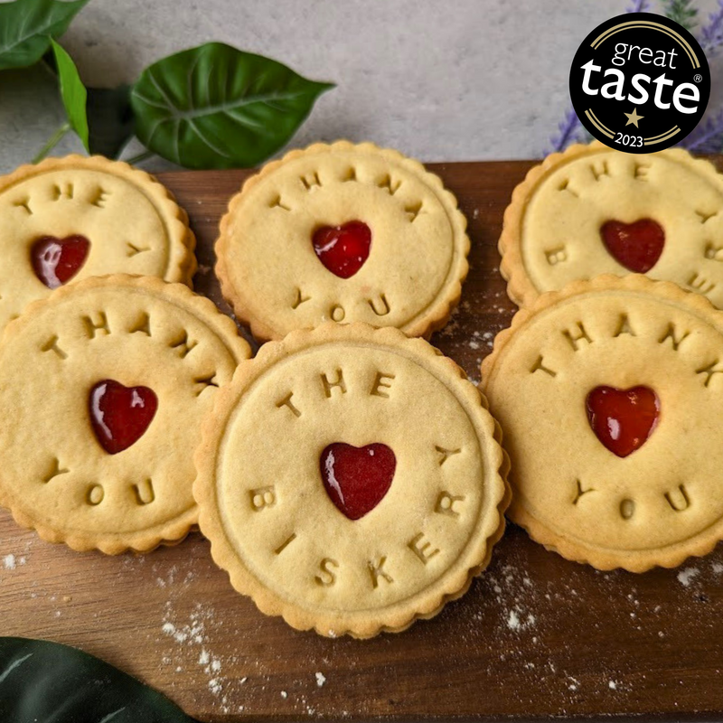 Jam biscuits in a gift box with "thank you" message and heart-shaped cutouts. Great Taste award winner.Jam biscuits in a gift box with "thank you" message and heart-shaped cutouts. Great Taste award winner.