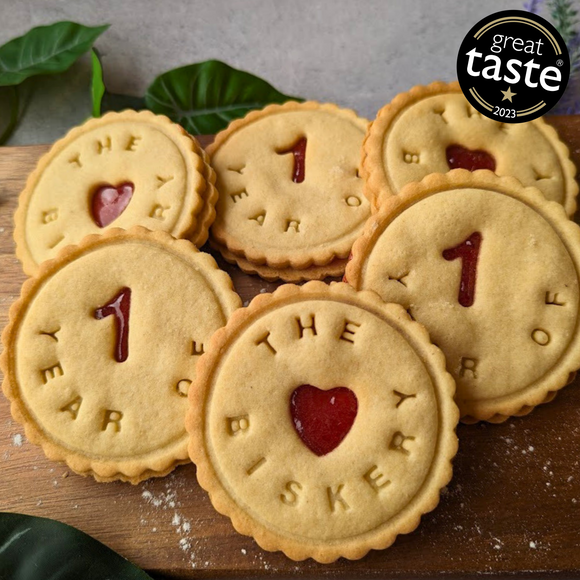  Jammy dodger biscuits celebrating "The 1st Year of The Biskery" with red heart-shaped jam filling